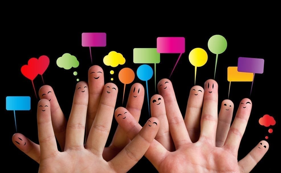 Image of hands with faces drawn on the fingers and thought boxes popping off each face.