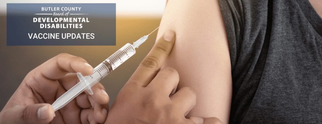 A syringe with needle is pressed against someone's arm. Text on the picture reads: The Butler County Board of Developmental Disabilities Vaccine Updatesi