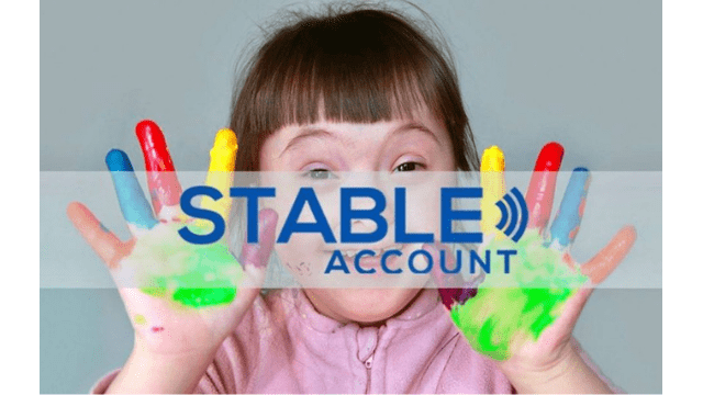 A girl with painted hands smiles at the screen. Superimposed over her image are the words: STABLE Account