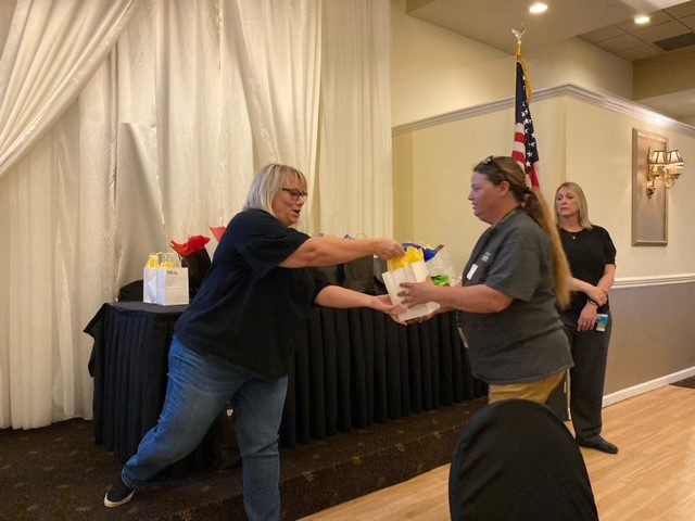 Connie Mehlman gives a 10 Year BCBDD Milestone Award to at Fairfield Receptions Banquet Center.