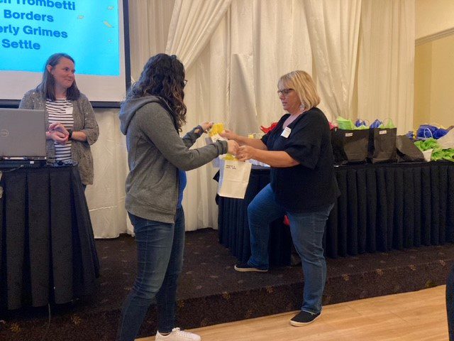 Connie Mehlman gives a 5 Year BCBDD Milestone Award to at Fairfield Receptions Banquet Center.