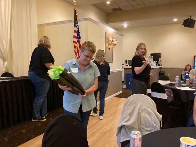 Sherry Dillion takes her BCBDD 20 year Milestone Award back to her table at the Fairfield Receptions Banquet Center.