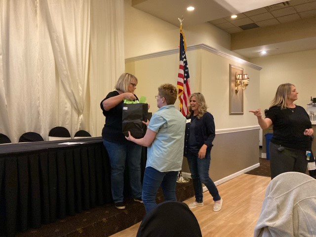 Connie Mehlman gives a 20 year BCBDD Milestone Award to Sherry Dillion at Fairfield Receptions Banquet Center.