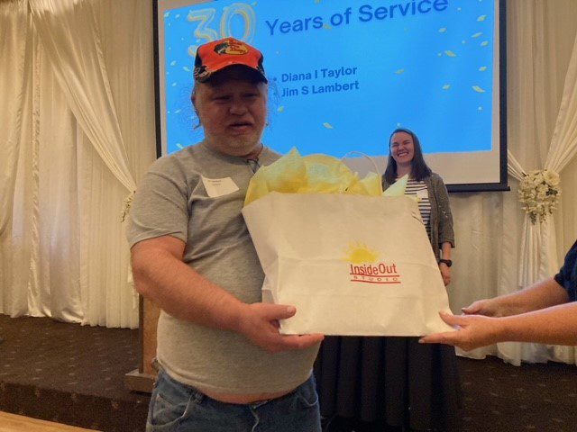 Jim S Lambert holds his 30 Year BCBDD Milestone Award at Fairfield Receptions Banquet Center.