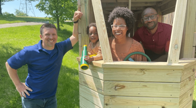 Family standing inside a helicopter playset