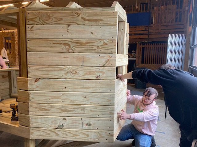 Two men building a playset