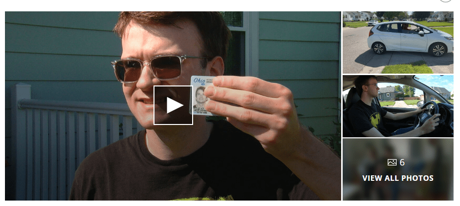 A man holds his license, covering the sensitive information with his hand. A play button is overlaid on the image. 