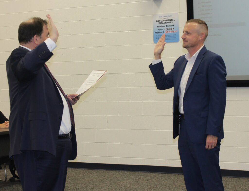 Dan Hughes being sworn in by a judge as a new board member