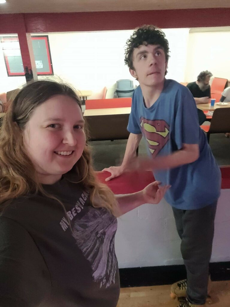 A woman and a man together indoors posing for a photo.