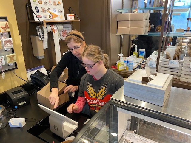 2 women in a kitchen working together on a computer