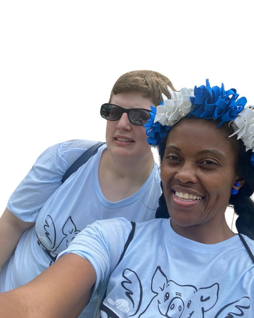 2 women standing together with blue matching shirts on