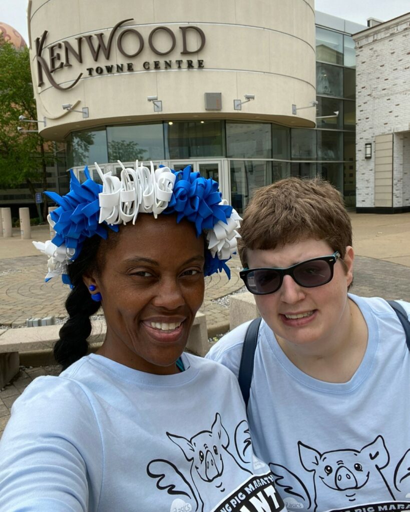 2 women outdoors standing in front of the Kenwood Towne Center.